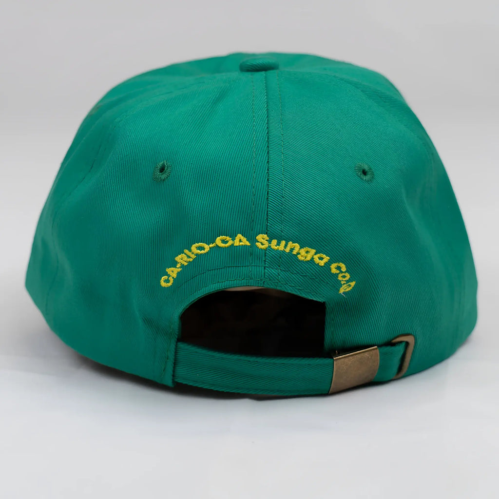 Back view of a vibrant green ca-rio-ca crest logo embroidered designer dad hat with yellow text and brass metal buckle