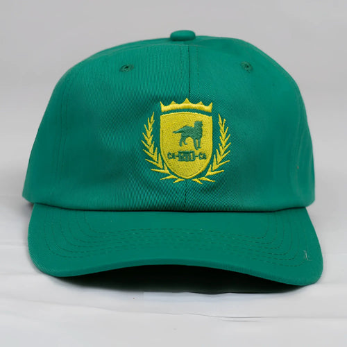 A vibrant green ca-rio-ca designer dad hat with a yellow embroidered dog crest and laurel wreath men’s baseball cap