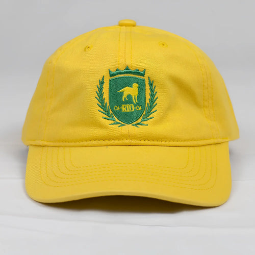 Bright yellow CA-RIO-CA designer dad hat featuring green embroidered dog crest and laurel wreath logo