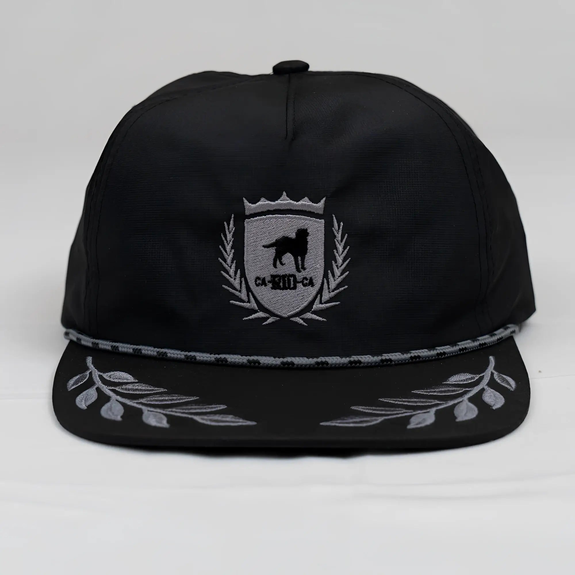 Black unstructured bay leaf snapback rope hat with silver embroidered ca-rio-ca crest featuring dog and laurel wreath