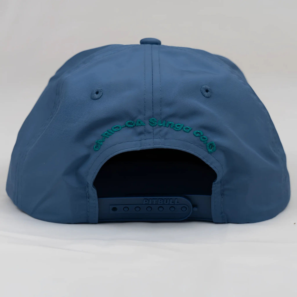 Blue unstructured bay leaf snapback rope hat with teal embroidered crest logo and black adjustable strap
