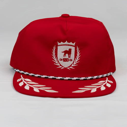 Red unstructured bay leaf snapback rope hat with white dog crest embroidery and black and white striped brim trim