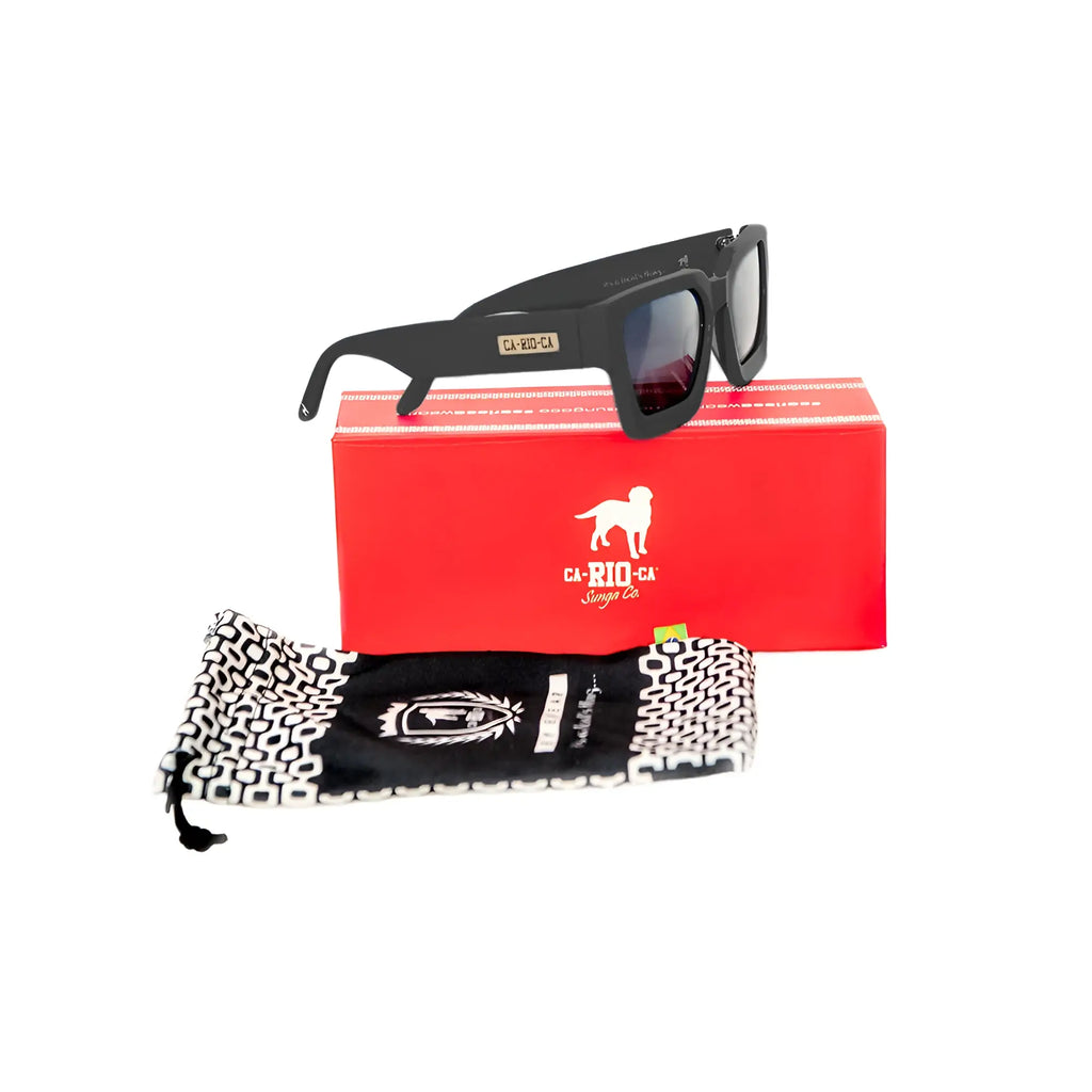 Black square-framed ca-rio-ca leblon sunglasses with dark lenses and gold label on temple on red branded box