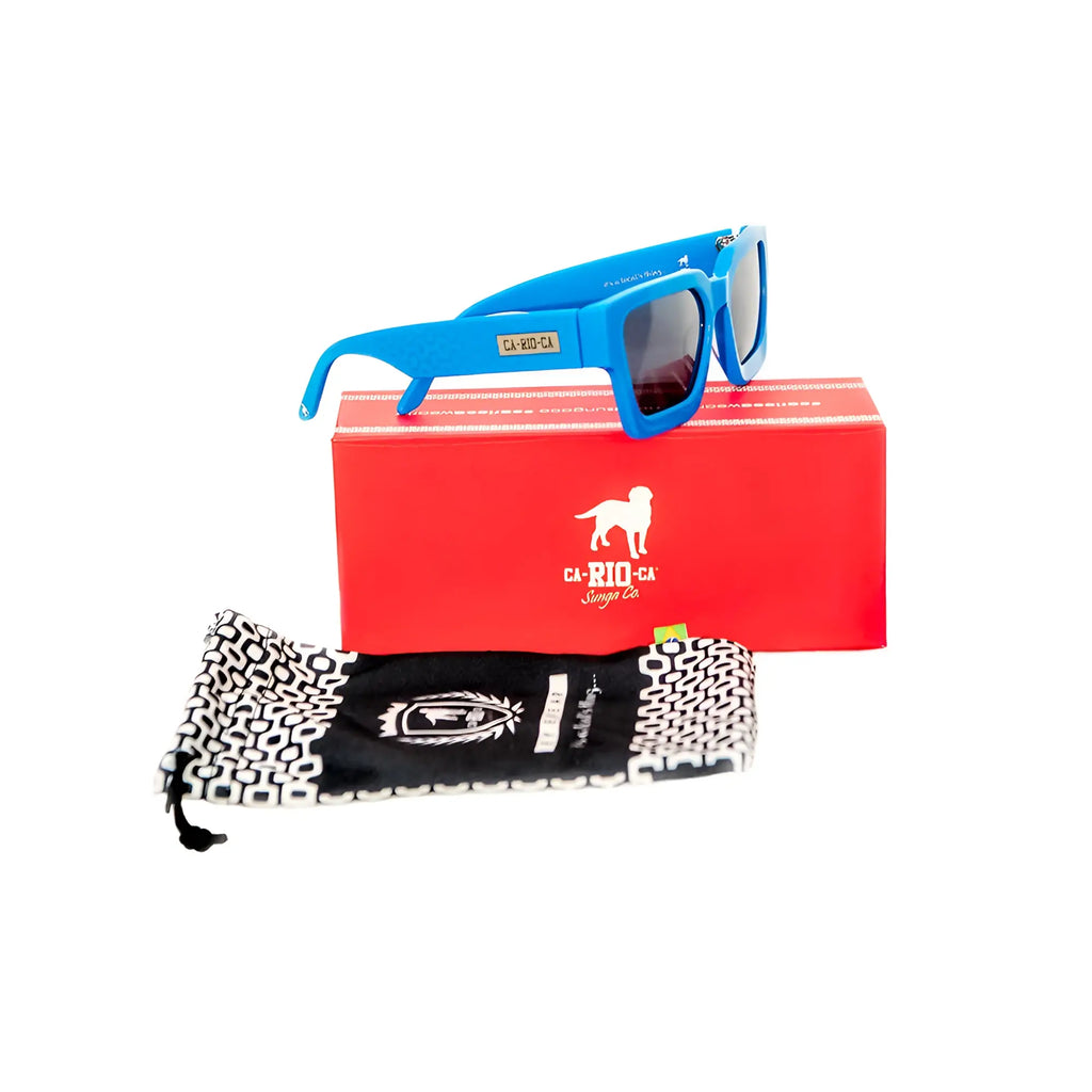Bright blue square-framed CA-RIO-CA Leblon sunglasses with dark lenses on red box and black-and-white pouch