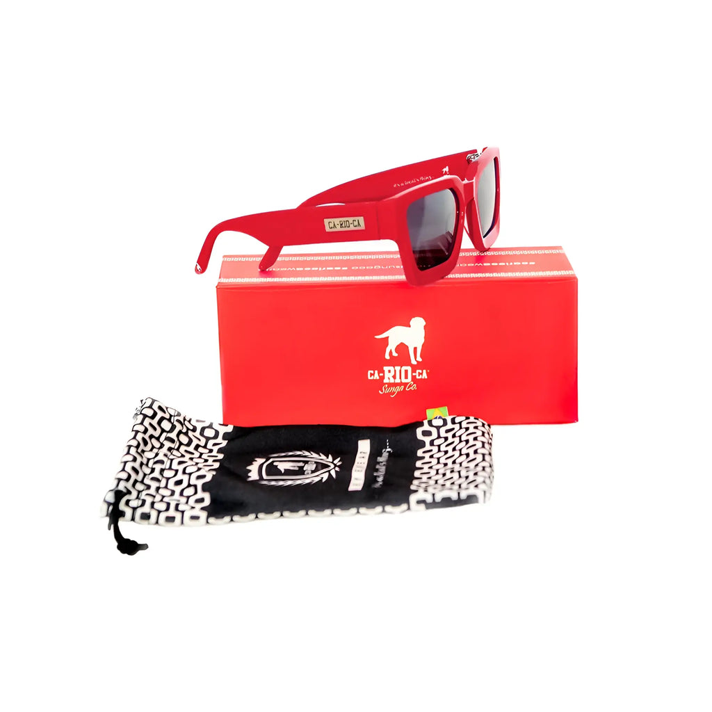 Red square-framed ca-rio-ca leblon sunglasses with dark lenses displayed on matching red box and black and white pouch