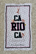 Gray brazilian beach towel with leopard print background black and pink trim featuring carioca text and monkeys