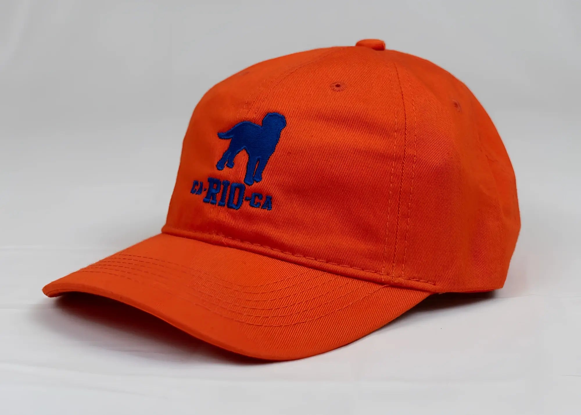 Bright orange ca rio ca logo embroidered designer dad hat with blue dog silhouette men’s baseball cap