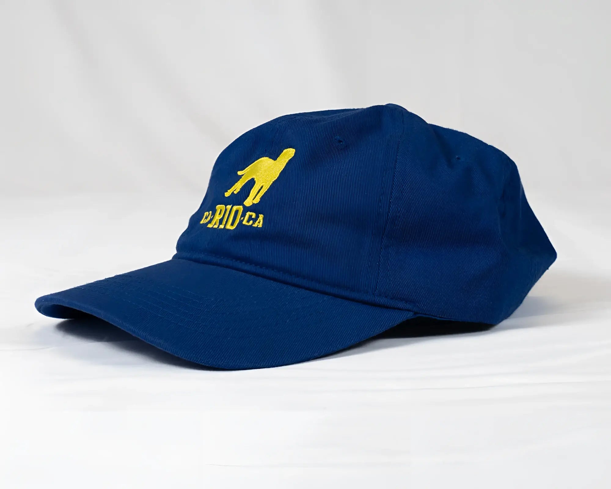 Navy blue ca-rio-ca logo embroidered designer dad hat with yellow camel and dried ca text men’s baseball cap
