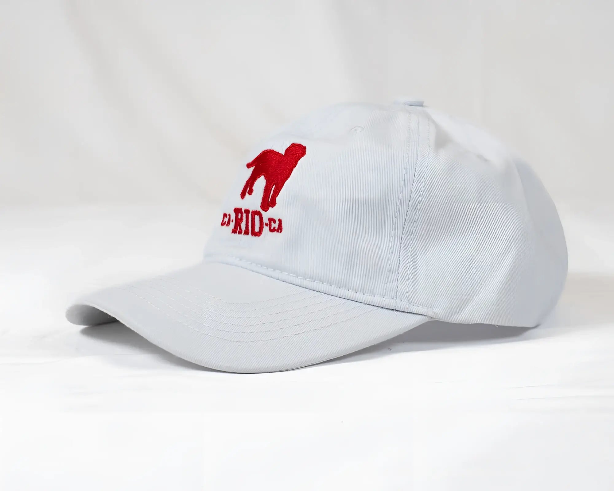 White CA-RIO-CA logo embroidered designer dad hat with red dog silhouette and c-rid-c text men’s baseball cap
