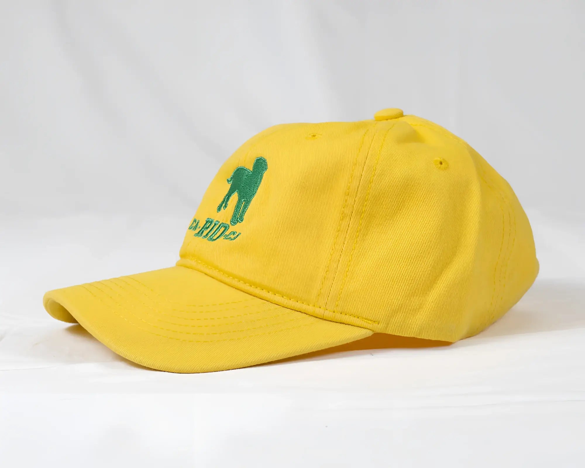 Yellow baseball cap with green embroidered poodle and CA-RIO-CA logo designed for men’s casual wear
