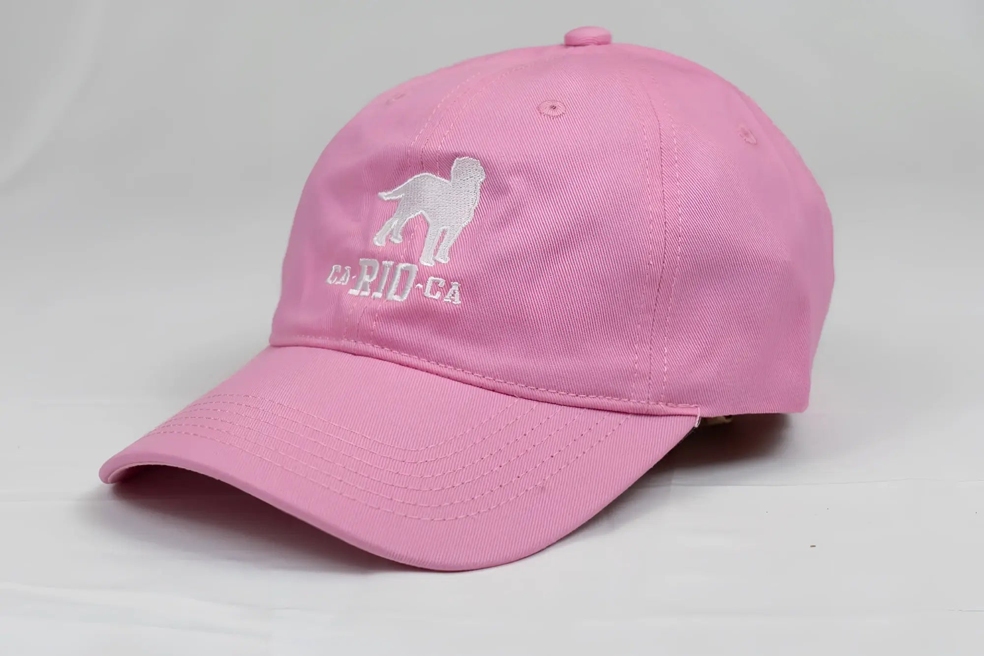 Pink ca-rio-ca logo embroidered designer dad hat with white dog silhouette and la rio ca text men’s baseball cap