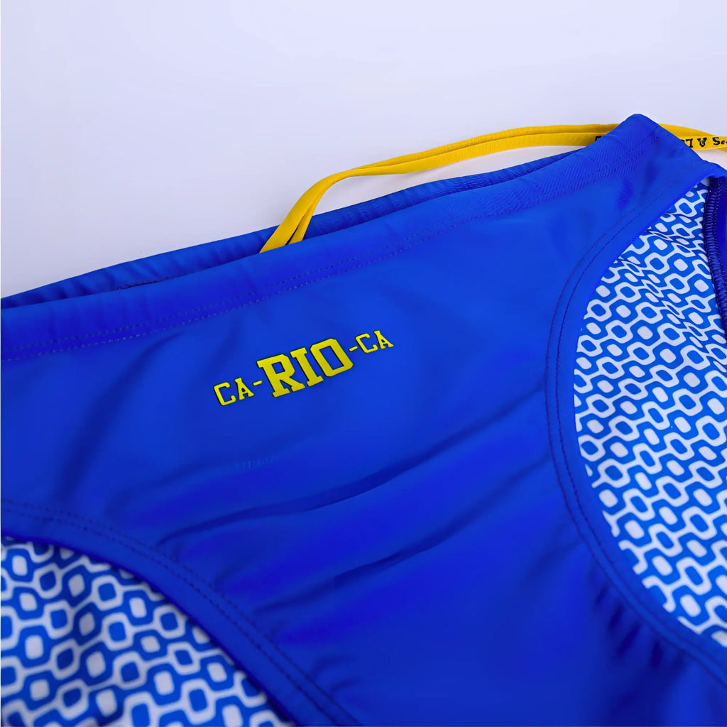 Men’s ca-rio-ca logo swim bikini blue swim trunks with yellow drawstring and white geometric side pattern for beachwear