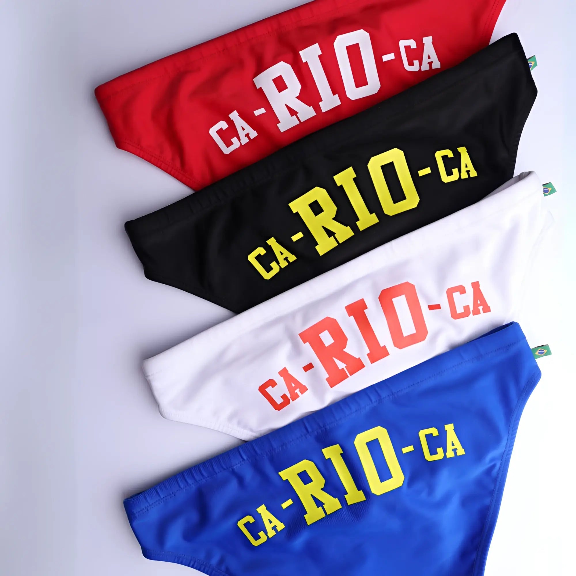 Red black white and blue athletic style men’s swimming sunga bikini bottoms with ca-rio-ca logo for beachwear