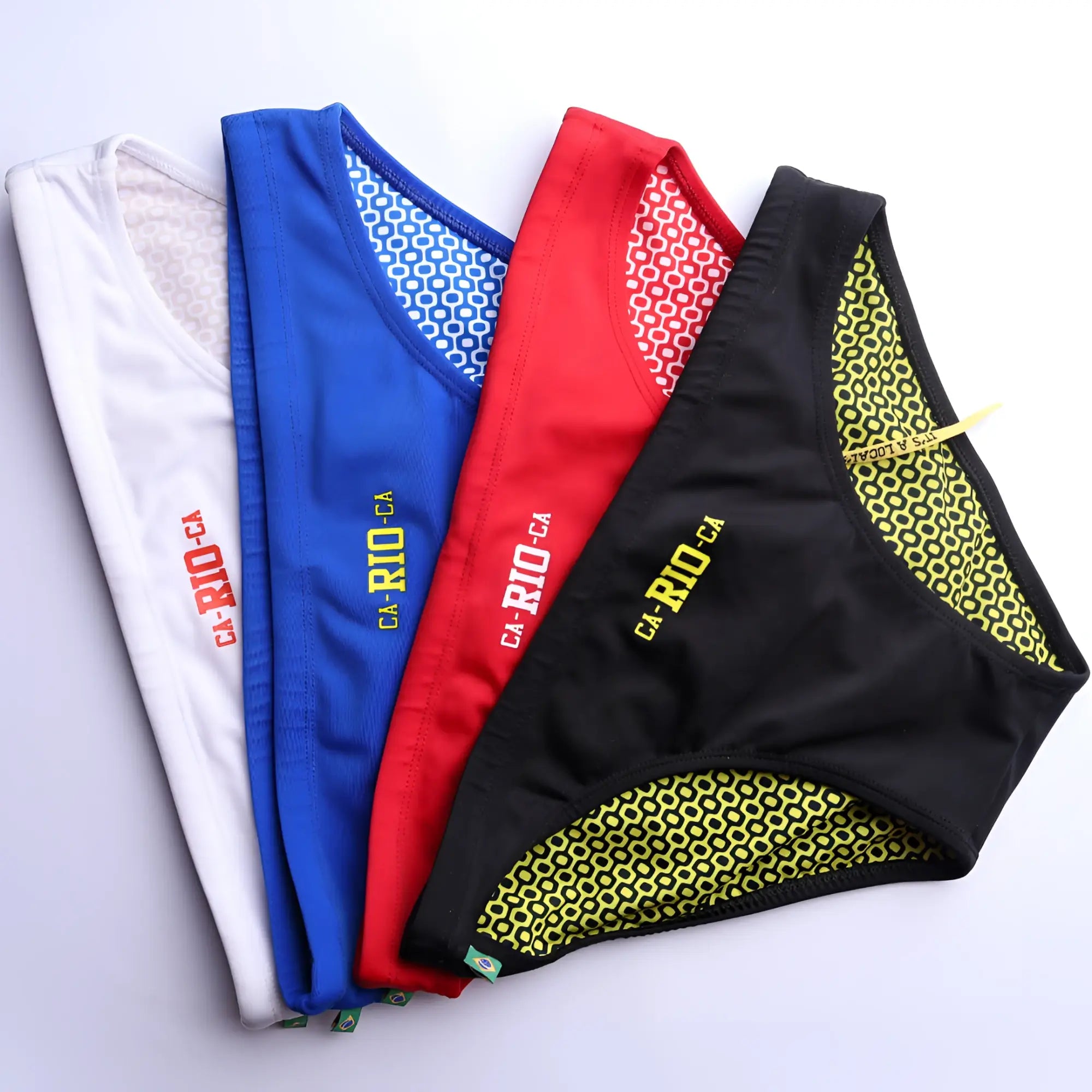 Set of four colorful ca-rio-ca logo swim trunks in white blue red and black with patterned lining for men beachwear