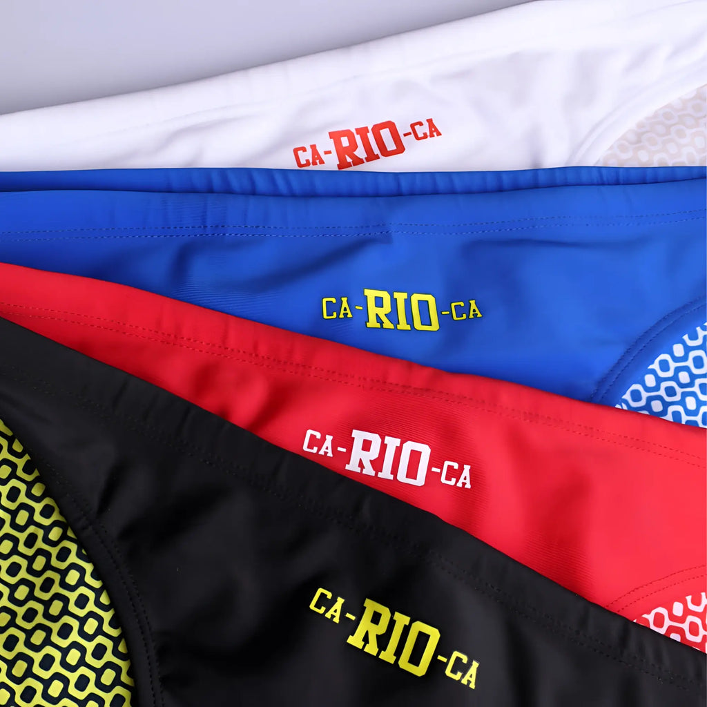 A set of four ca-rio-ca logo swim trunks in white blue red and black with contrasting embroidered lettering for men