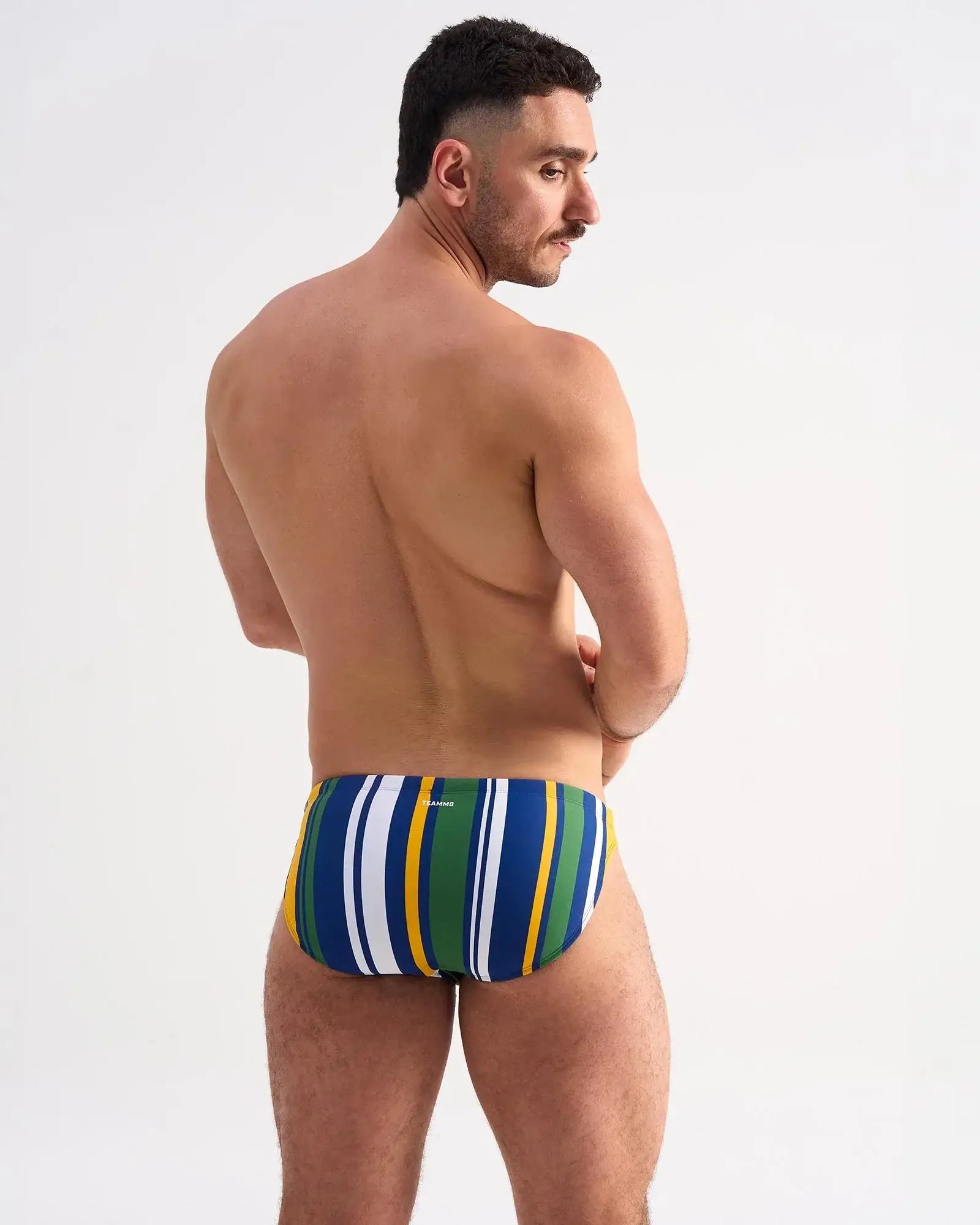 Men’s cabana swim brief with bold vertical stripes in blue green yellow and white for beach and pool use