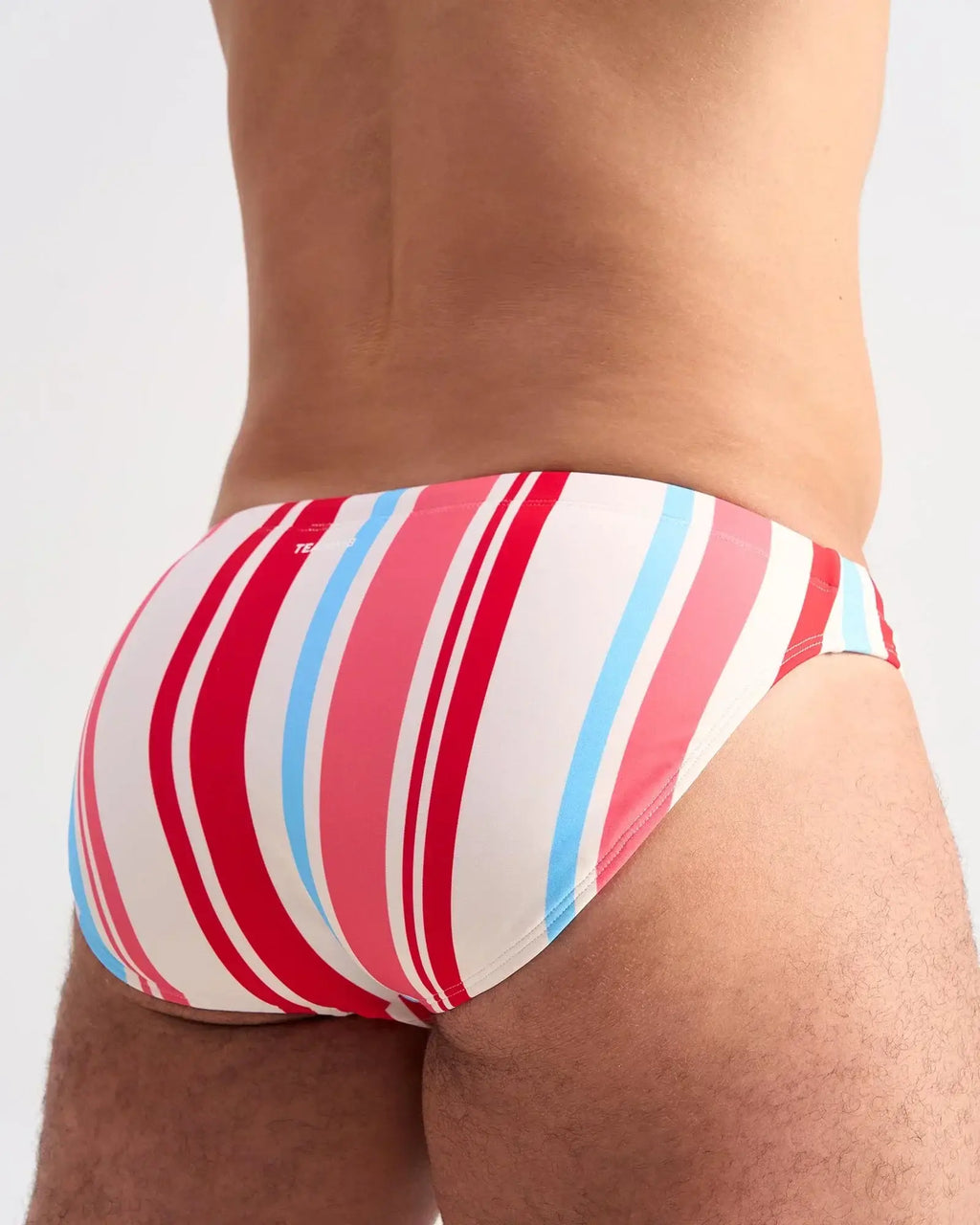 Cabana swim brief men’s trunks feature red pink and light blue vertical stripes perfect for beachwear