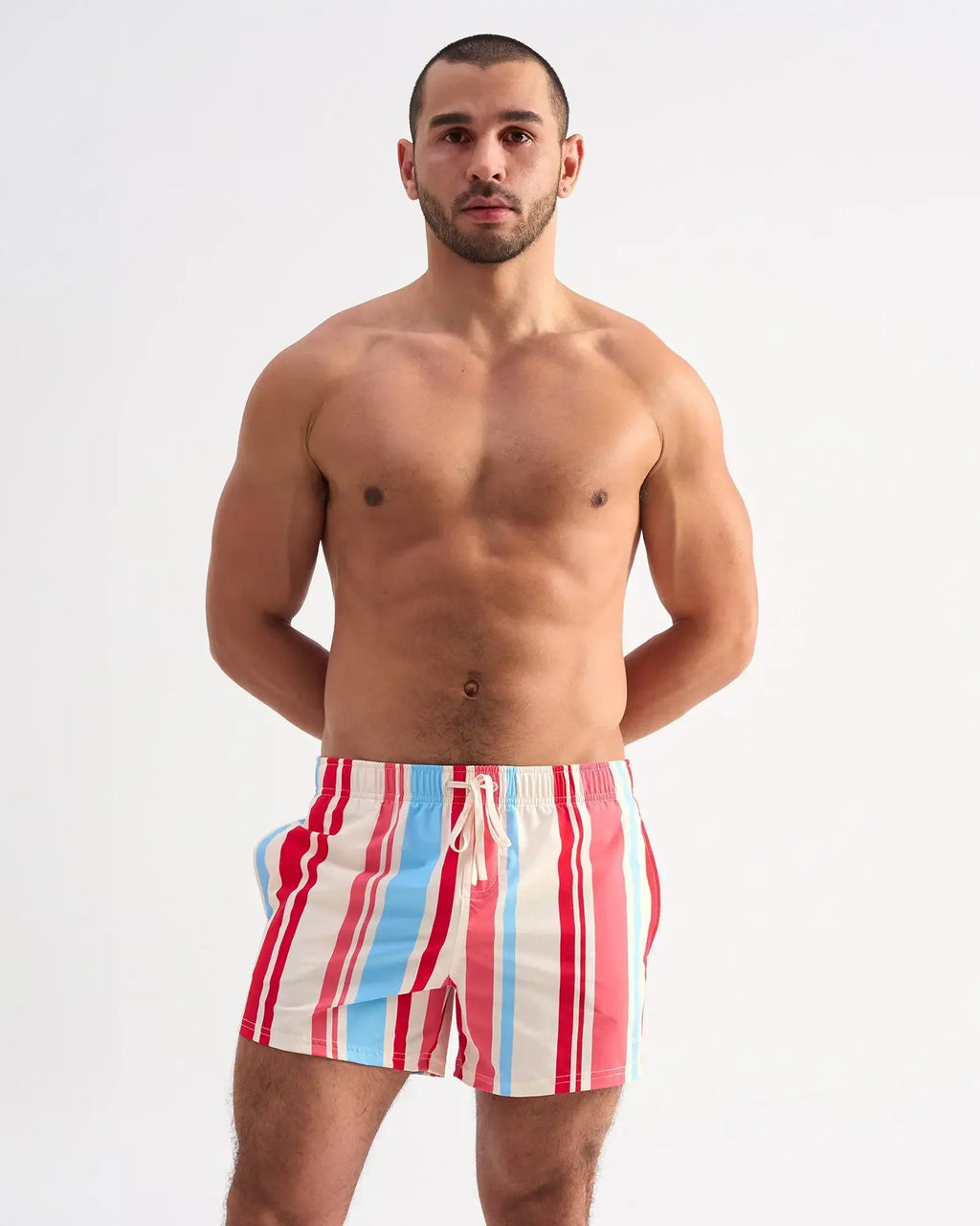 Men’s cabana swim short with bold vertical stripes in red light blue and white designed for swimming and beachwear