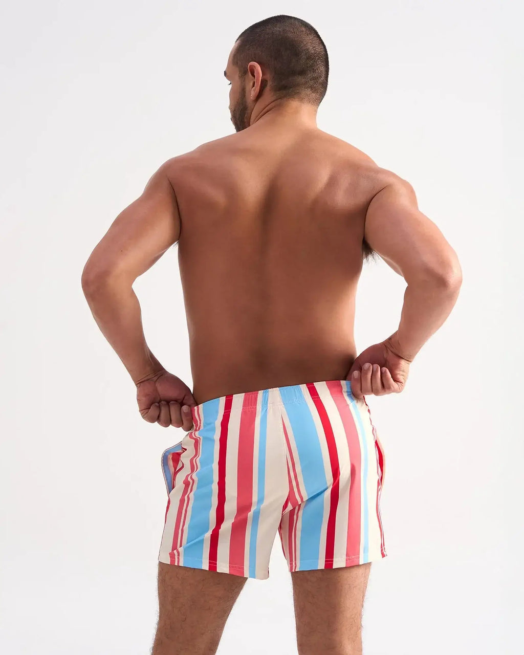 Men’s cabana swim short featuring bold vertical stripes in red light blue and white perfect for beachwear