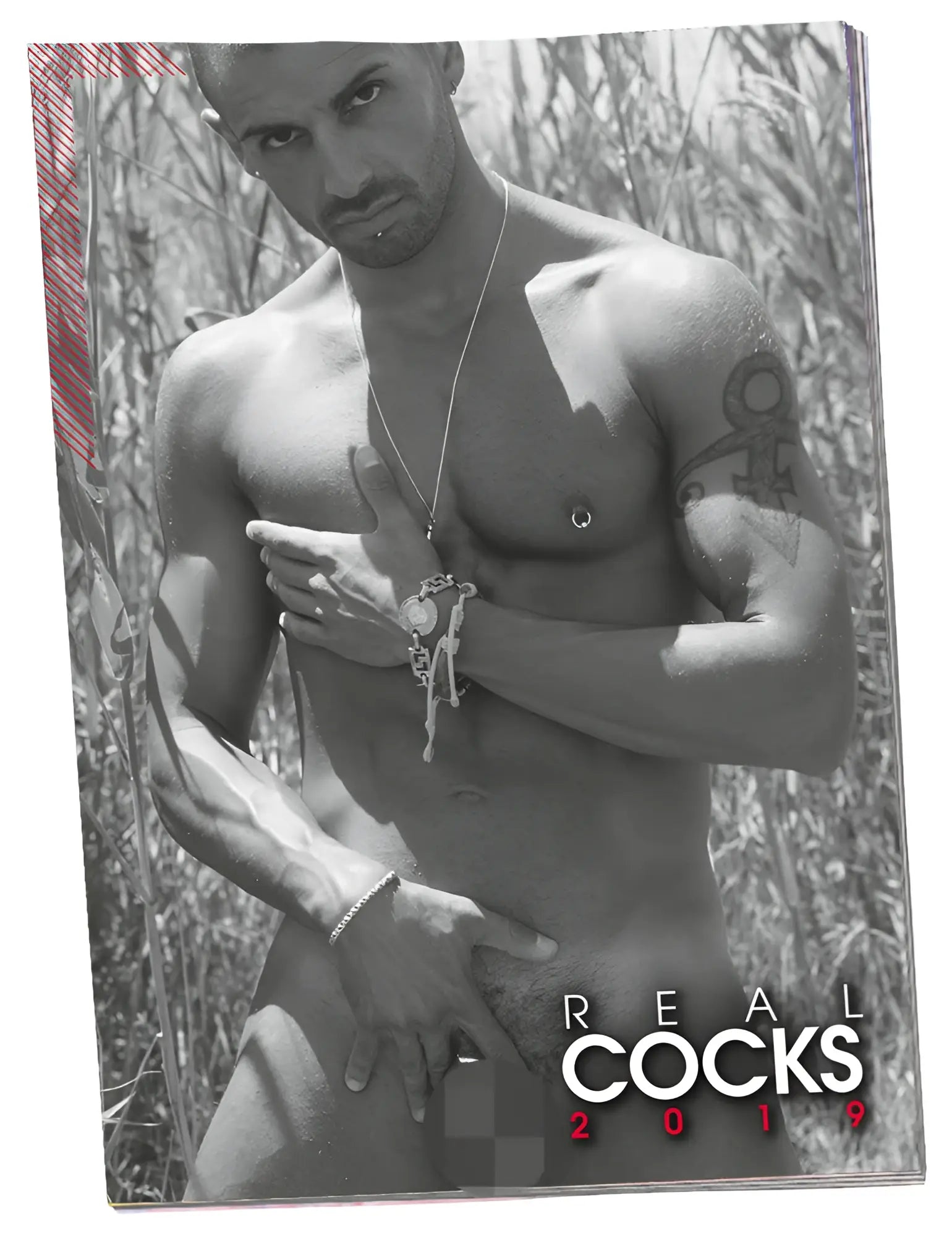 Black and white magazine cover of a muscular tattooed man wearing silver chain necklace and bracelet calendar 2019 pin up real cocks