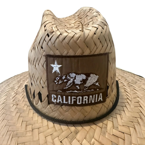 A tan woven straw cowboy hat with a brown california bear patch and black trim called California Patch Lifeguard Straw Hat