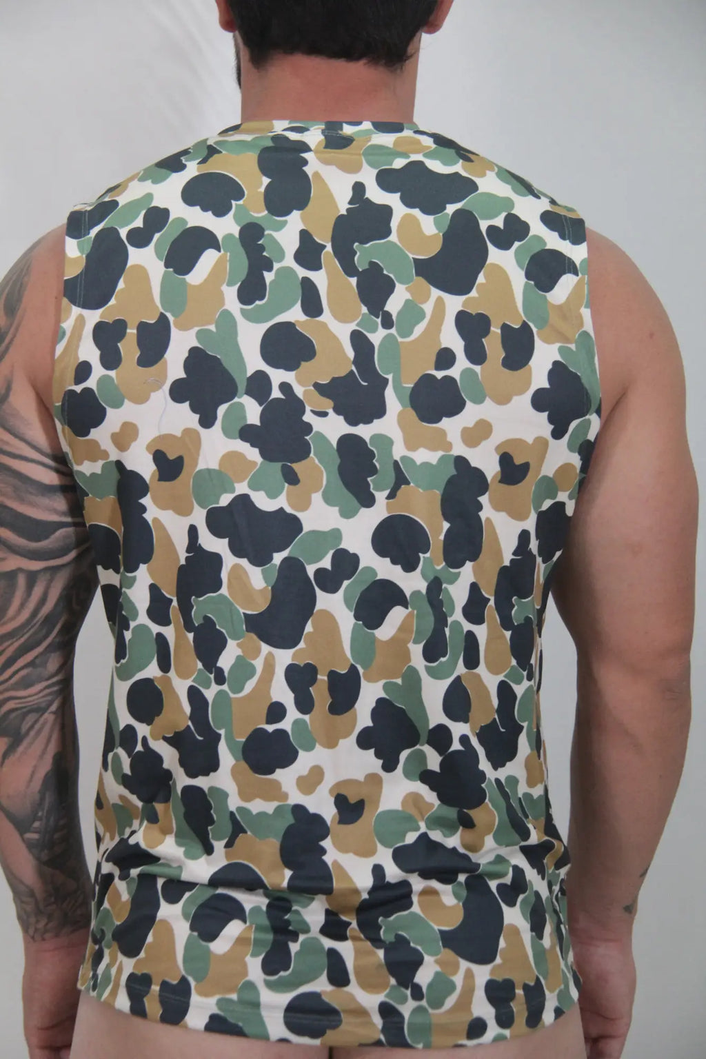 Camouflage open arm tank sleeveless top with olive green tan and black splotches on white base for casual wear