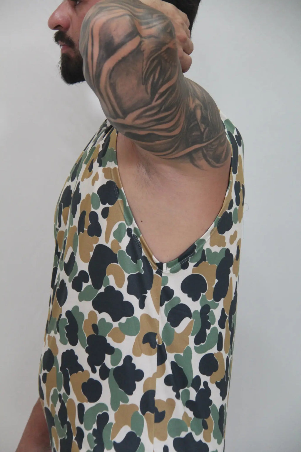 Camouflage open arm tank sleeveless top with white base and black olive green splotches for casual wear