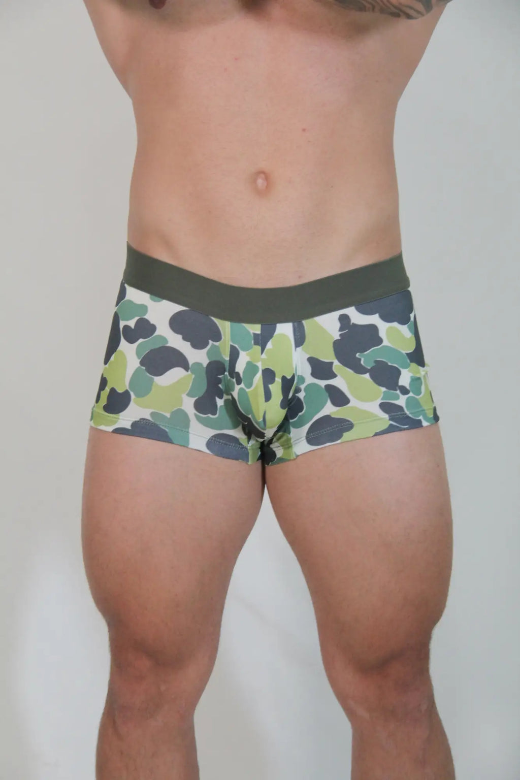 Green and black camouflage patterned briefs with solid olive green waistband called camouflage trunk