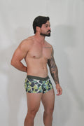 Green and black camouflage trunk briefs with a solid dark green waistband for comfortable everyday wear