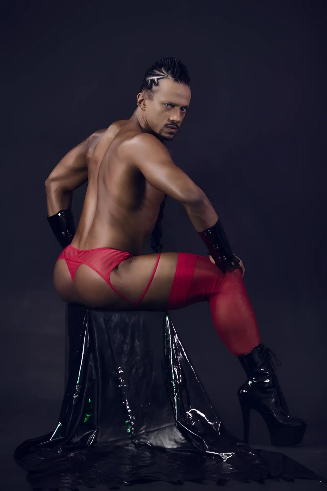 Red latex mesh garter thongs with matching arm cuffs and black high-heeled boots from candyman