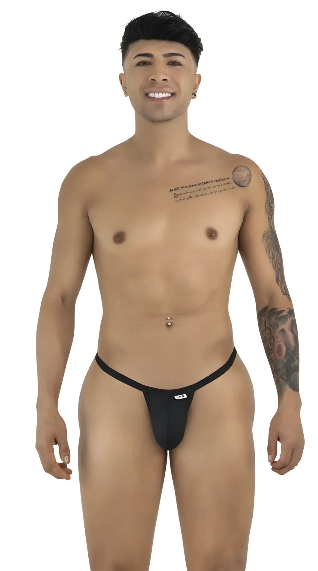 A smiling man with tattoos and a navel piercing models a minimalist black CandyMan thong against a white background.