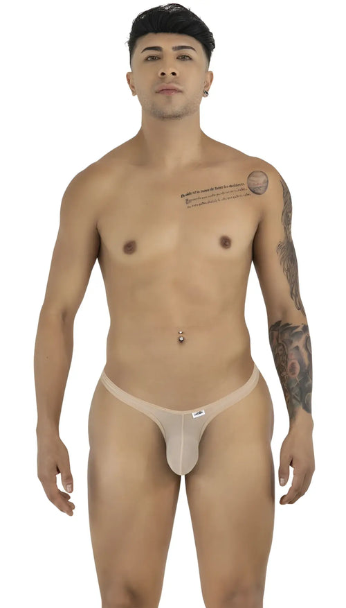 A man wearing beige mesh thongs, posing front-facing against a white background.