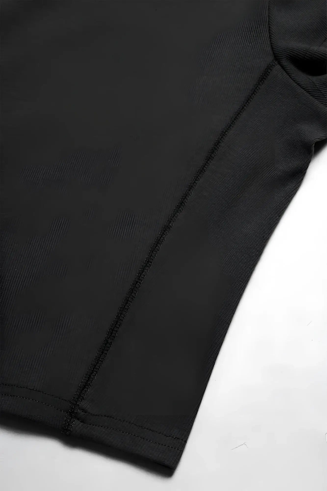 Black cap sleeve rib knit crop top with smooth fitted fabric and clean stitching along the seam