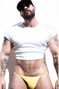 Yellow thong briefs made of rib knit fabric shown from the back complementing the ivory cap sleeve crop top