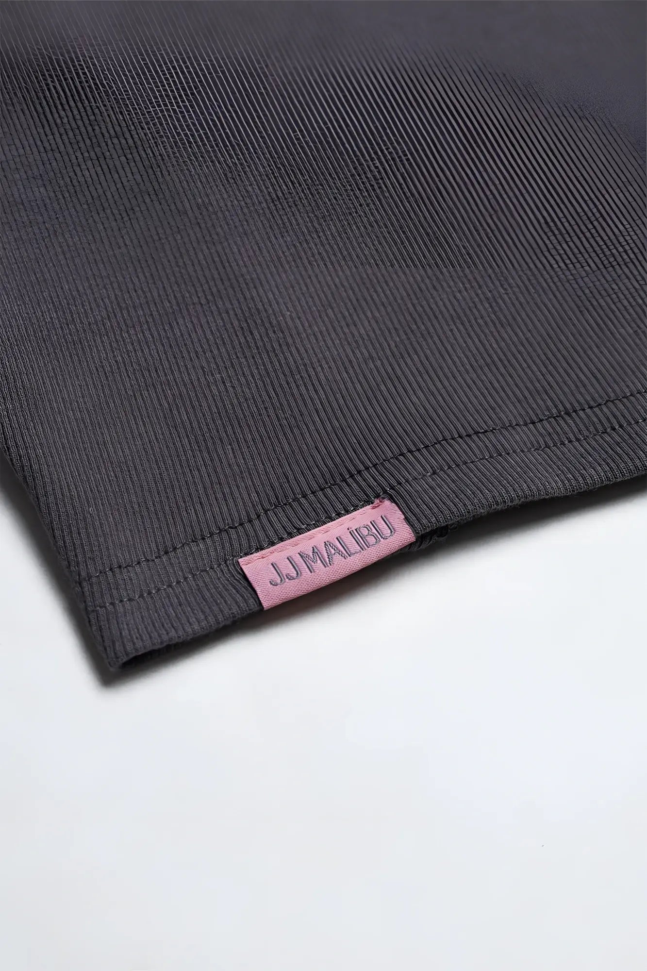 Dark gray ribbed knit cap sleeve crop top with pink jj malibu label in storm grey color