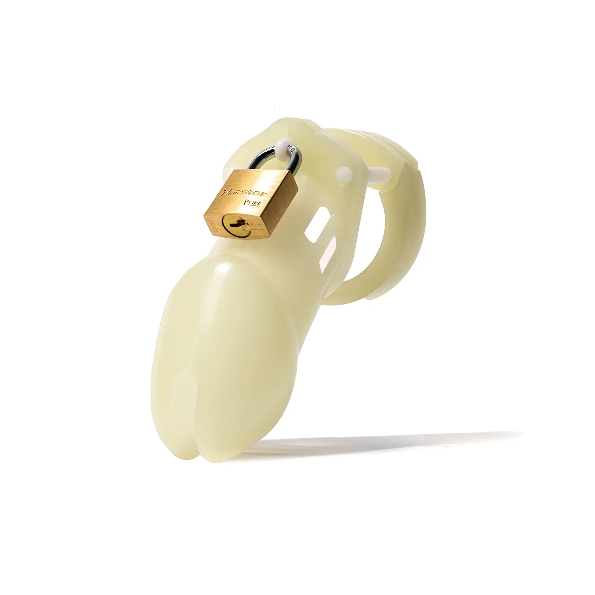 Glow-in-the-dark CB-X CB-6000 chastity cage in pale off-white, secured with a small brass Master padlock.