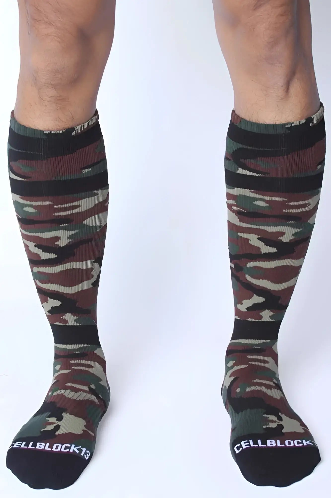Camouflage-patterned knee-high socks with black ribbed cuffs and toe caps in green brown and beige by cellblock 13
