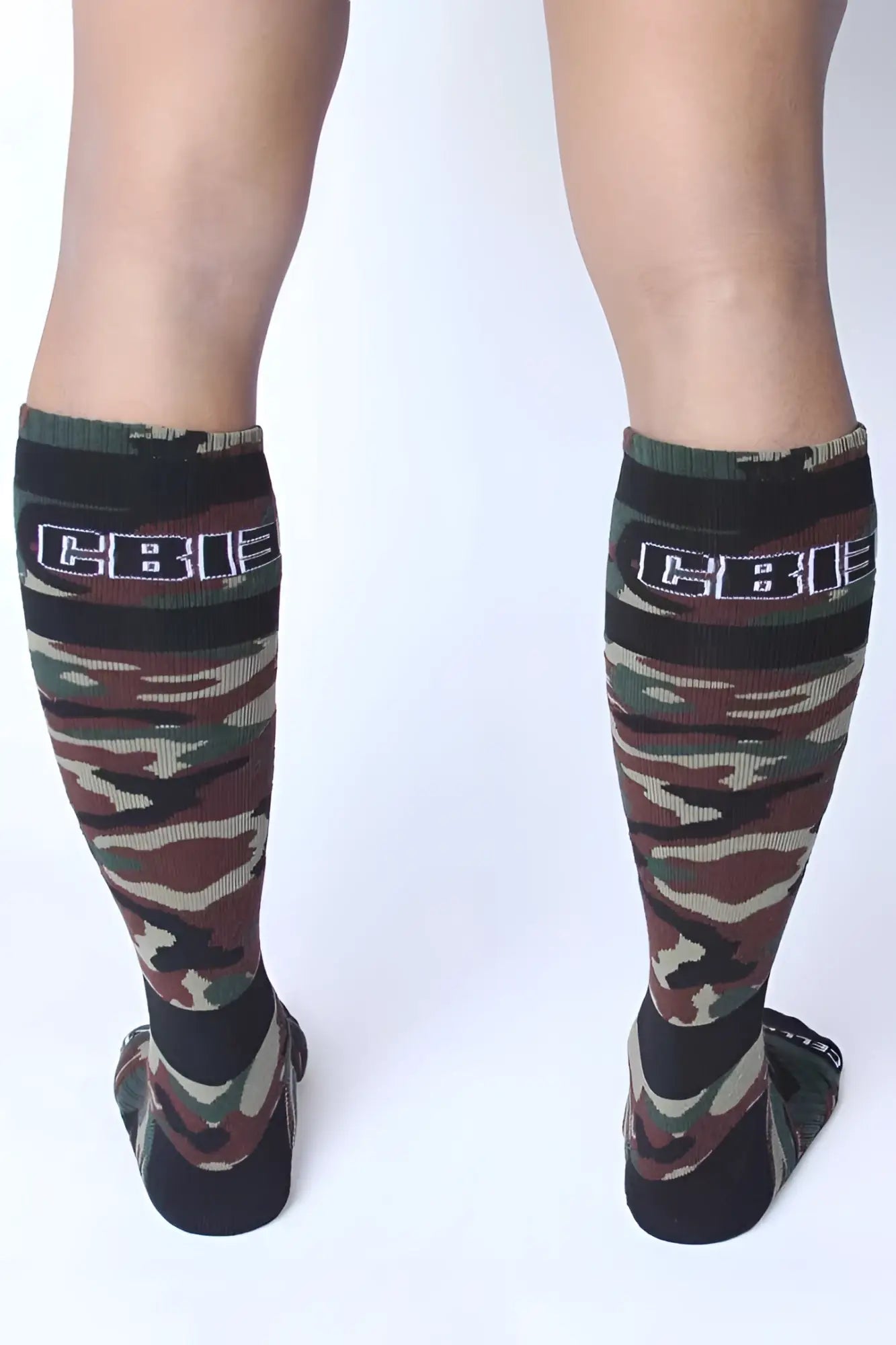 Green camouflage knee-high socks with black ribbed cuff and cbi logo by cellblock 13 foxhole socks size one size