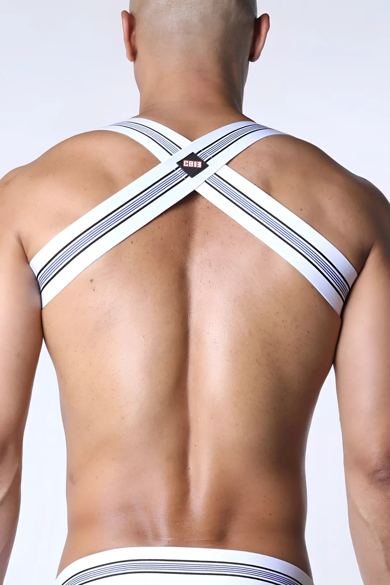 White and navy striped cross-back men’s tight end elastic harness underwear with small black logo patch at center