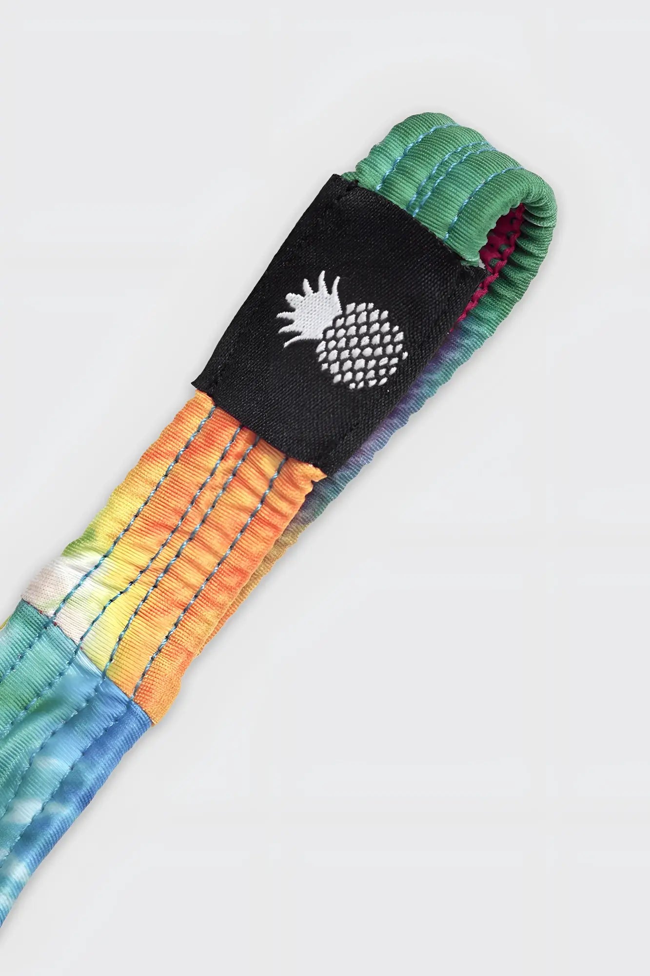 Cheeky classic g-string thong with rainbow tie-dye fabric strap and black patch featuring white pineapple logo