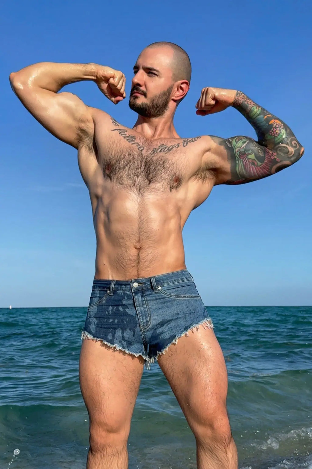 Blue denim cheeky summer 2.5 inch brief shorts with frayed hem in true blue shown from the back side