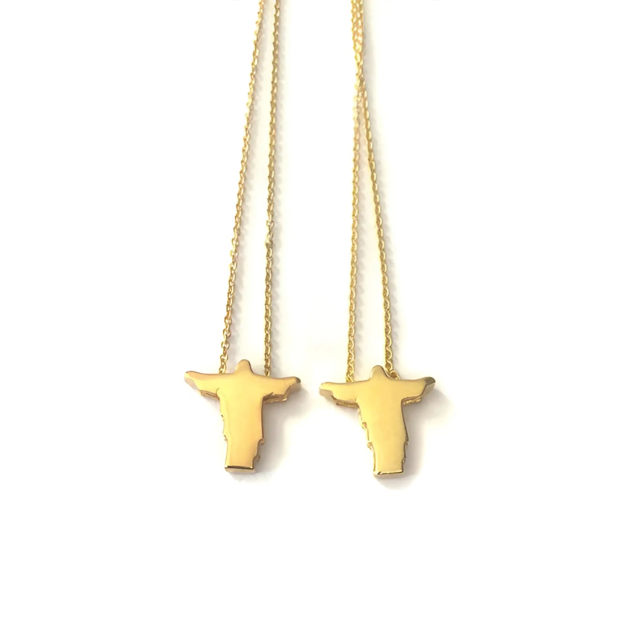 Gold-colored male cross necklace featuring a minimalist silhouette of the christ the redeemer statue in men’s fashion jewelry