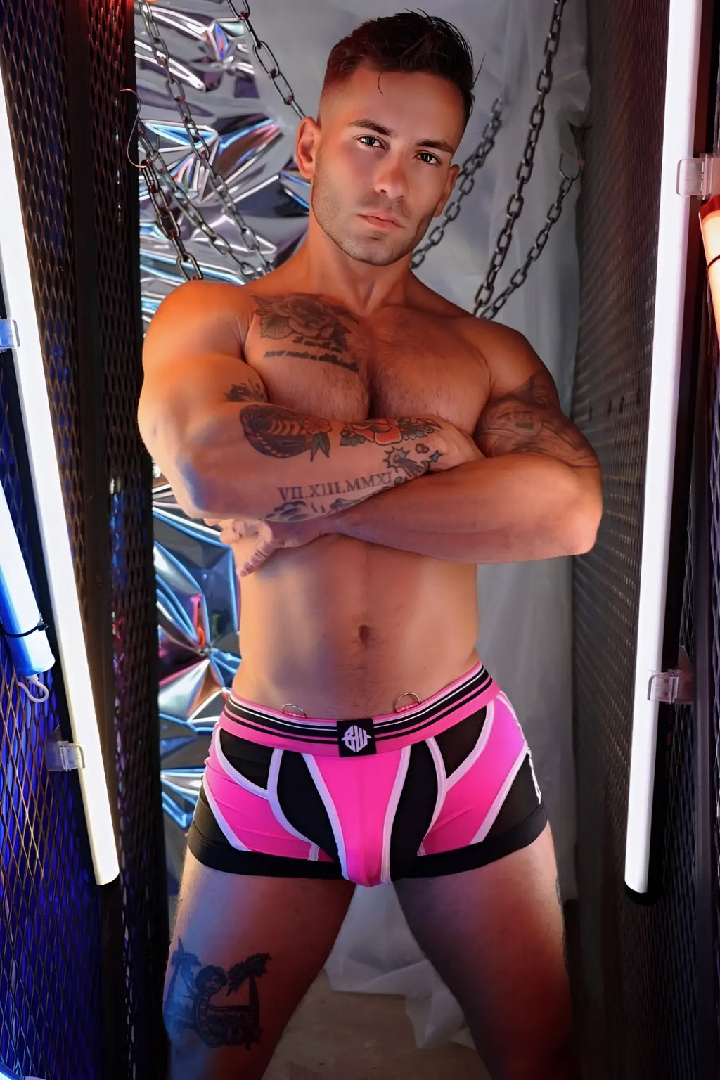 Bright pink and black circuit breaker boxer brief with white stripe trim and small logo on waistband in athletic fabric