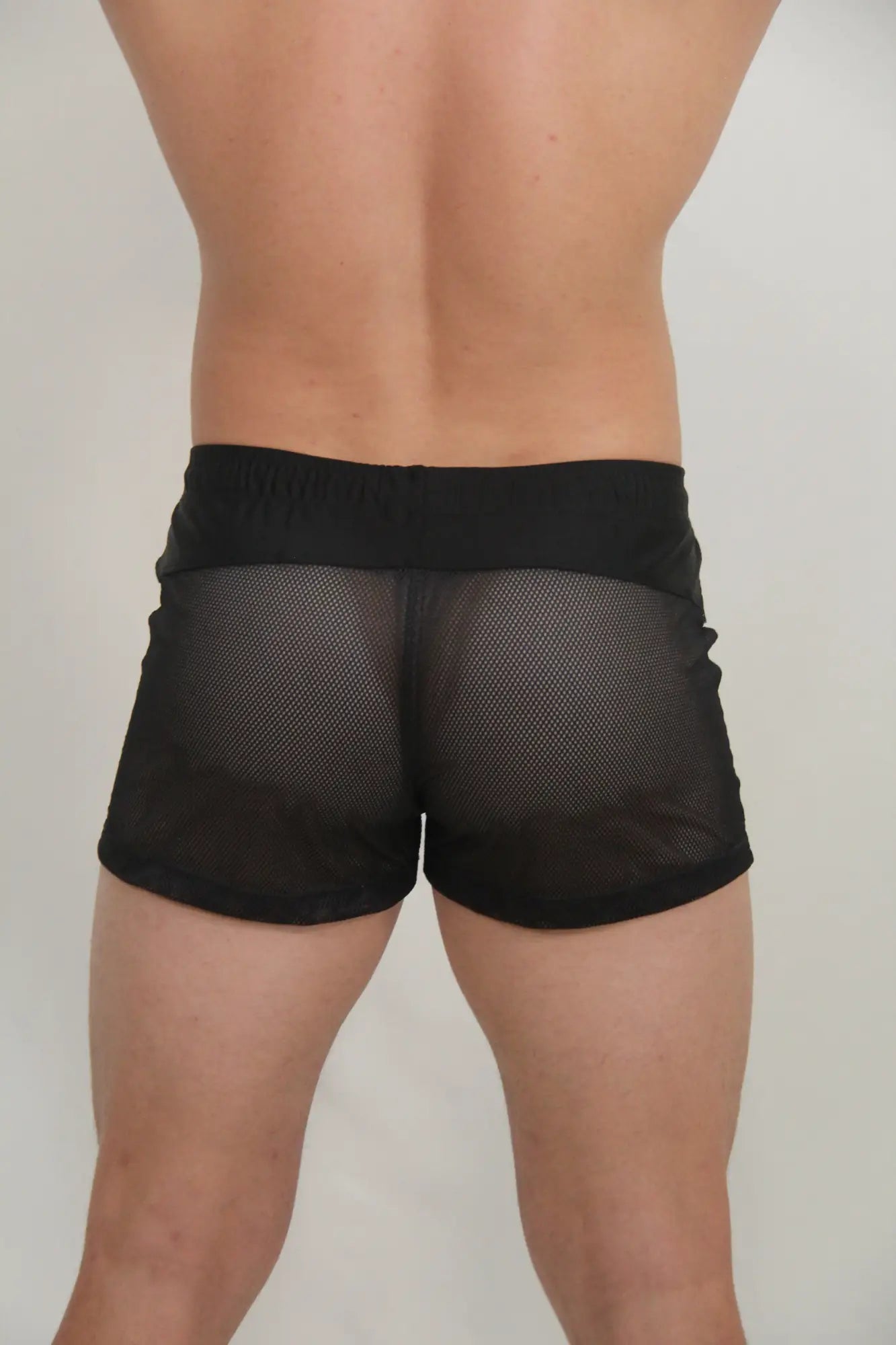 Black mesh circuit shorts with solid black waistband designed for breathability and athletic use in four colors available