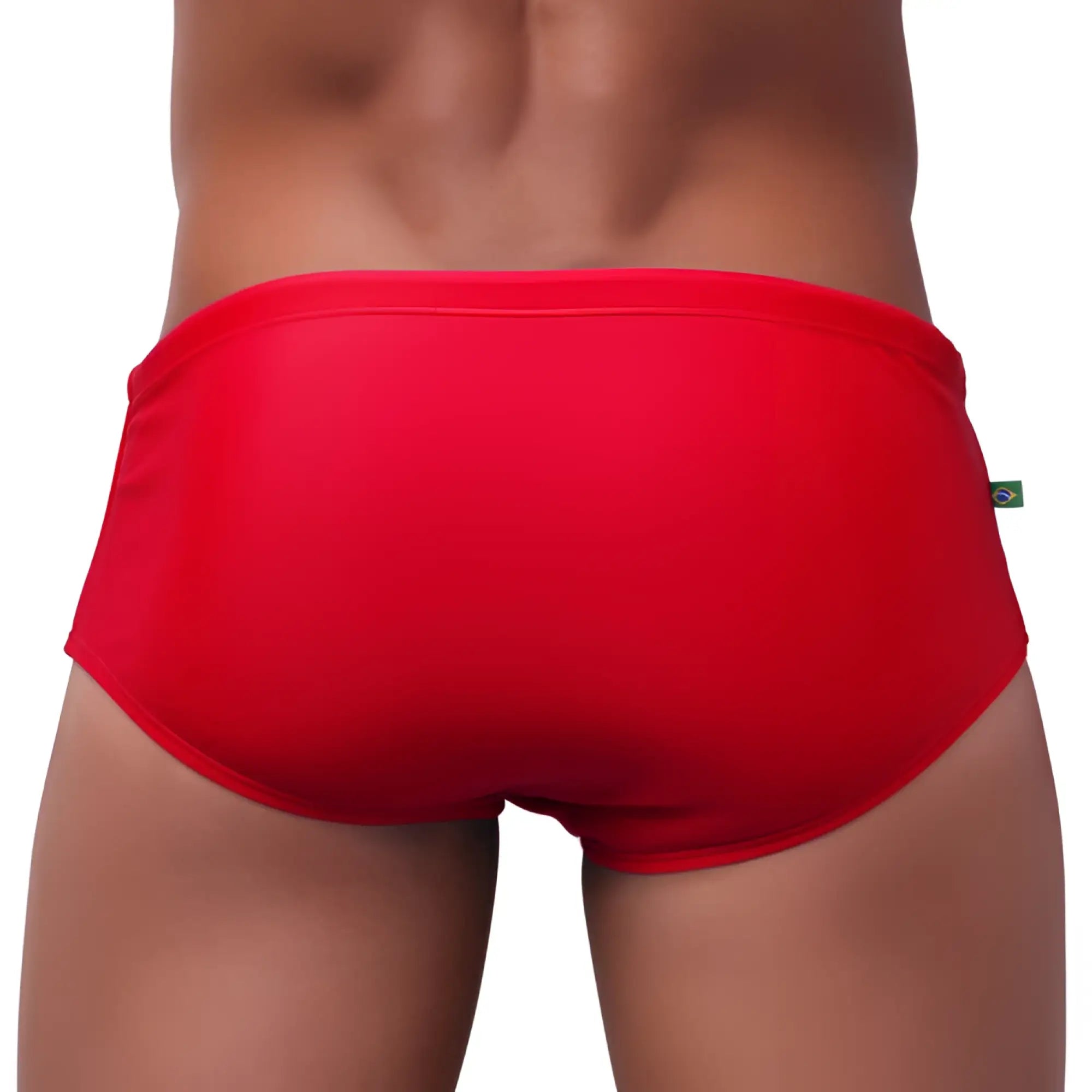 Classic cut solids sunga bright red swim trunks with smooth form fitting fabric and small green tag on the waistband