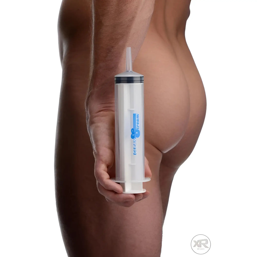 CleanStream 150ml clear plastic enema syringe with a blue logo, held by a person.