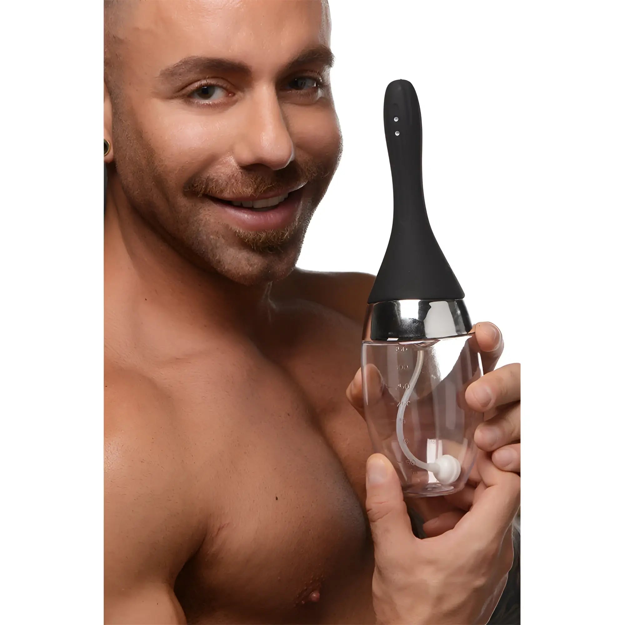 A man smiling, holding a CleanStream Auto-Vibrating Enema Bulb with a clear base, silver neck, and black nozzle.