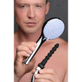 A man holding a chrome CleanStream shower enema set with a white spray head and a black ribbed silicone nozzle.