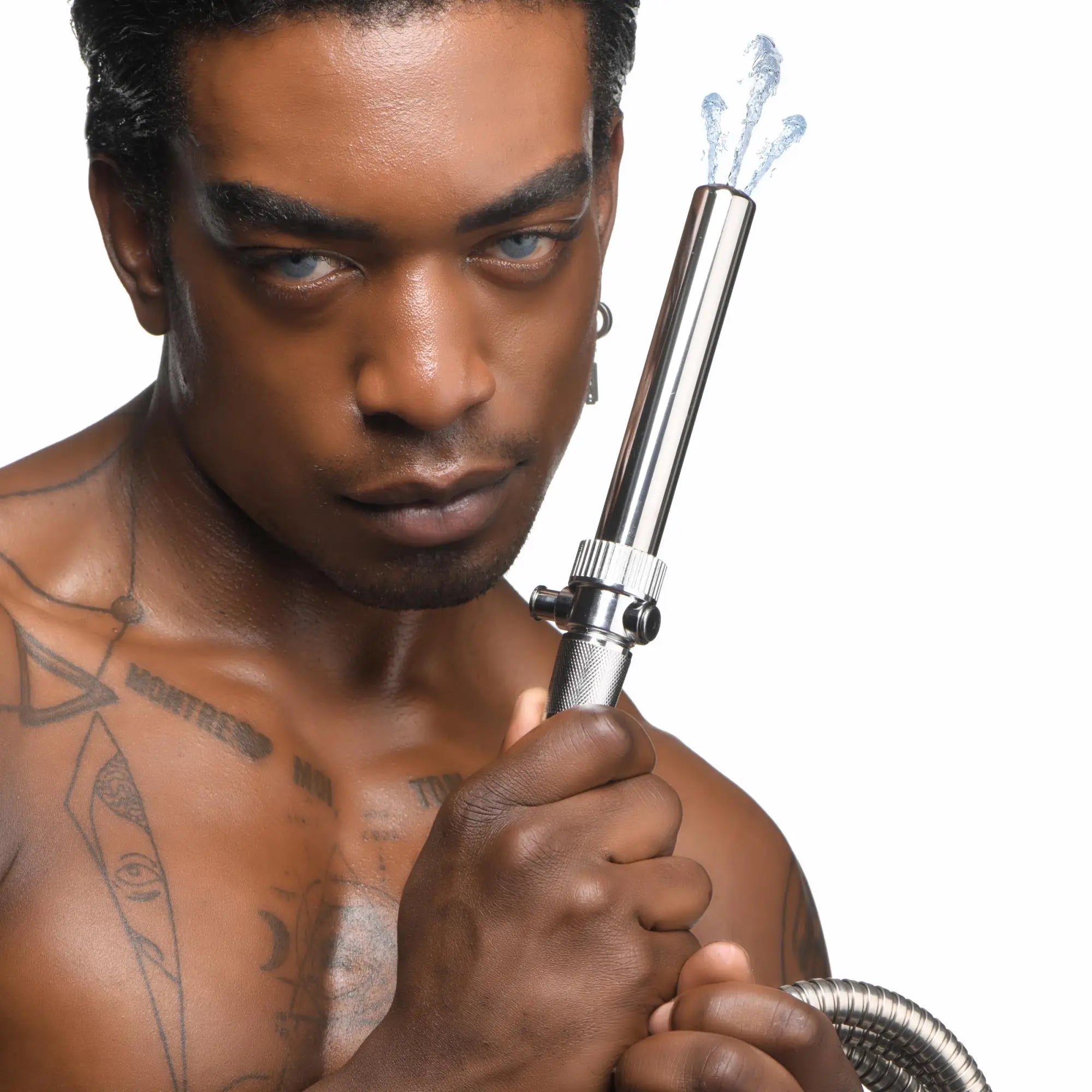 CleanStream Enema Nozzle, a silver stainless steel nozzle with shut-off valve, spraying water, held by a shirtless man.