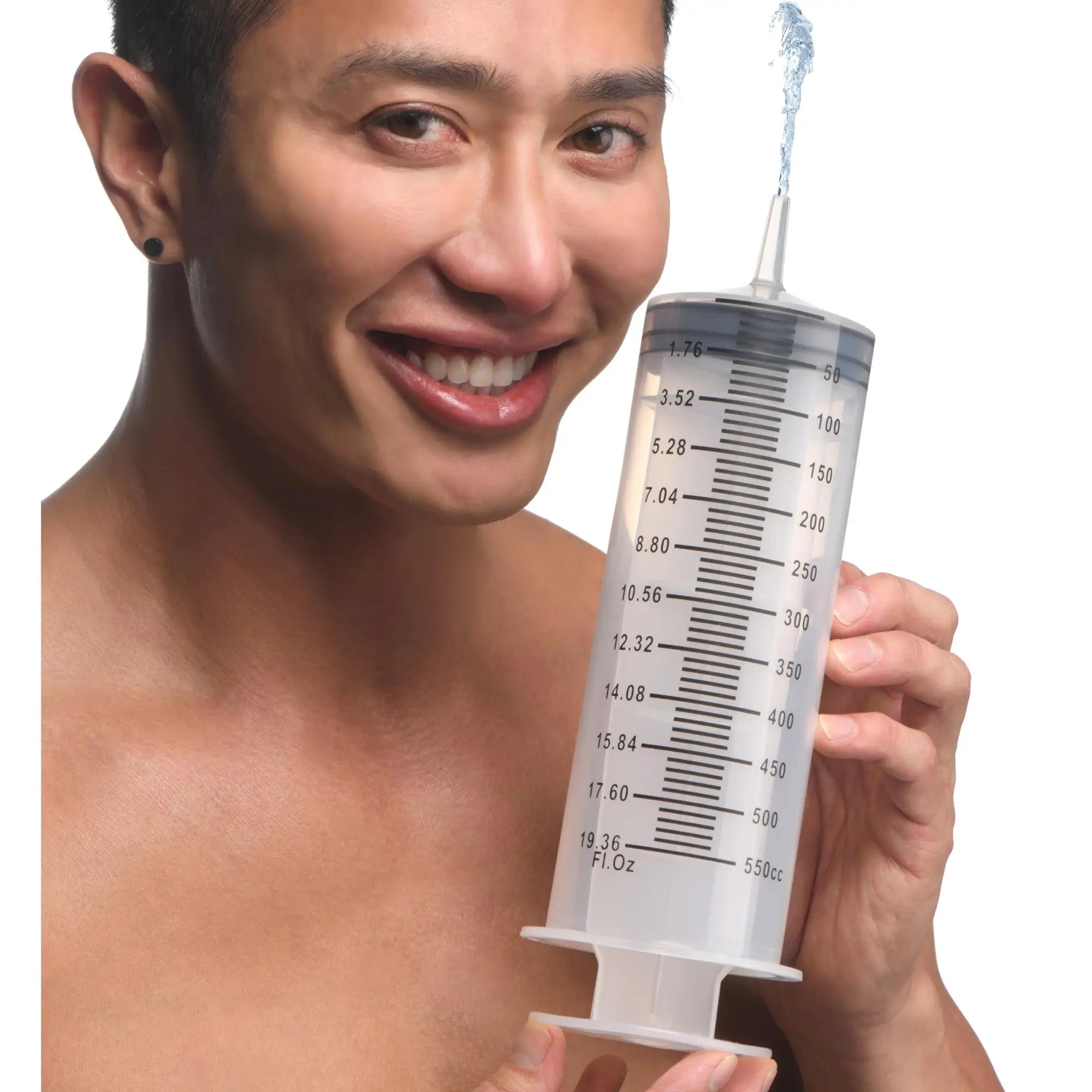 CleanStream Enema Syringe: A man holding a large, clear, graduated plastic syringe spraying a stream of water upward.